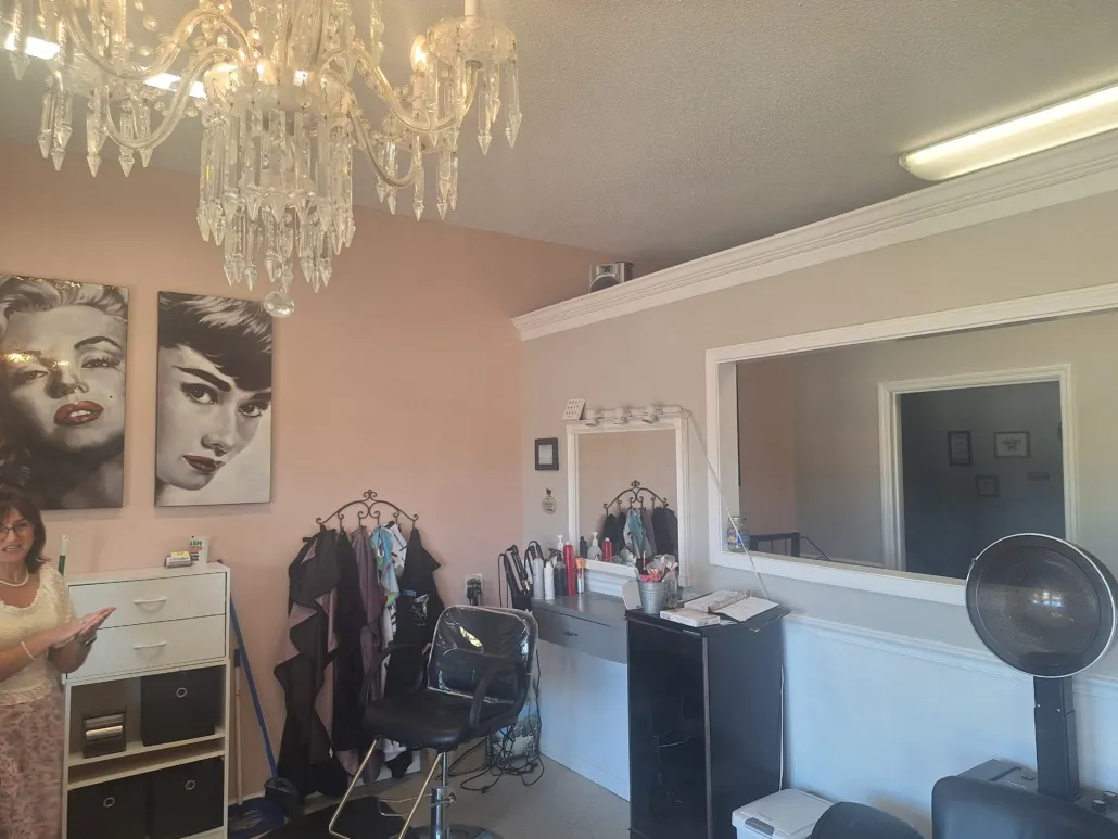The styling room at Creations, pink walls and a crystal chandelier